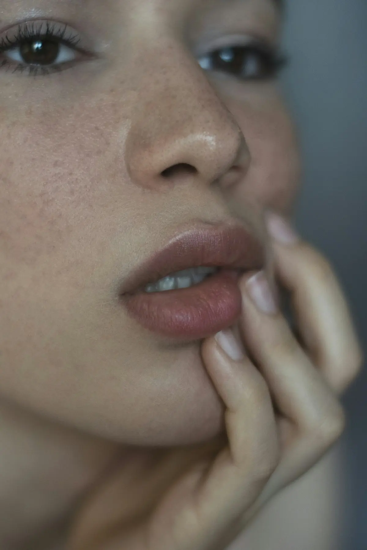 Close-up portrait showing natural freckled skin